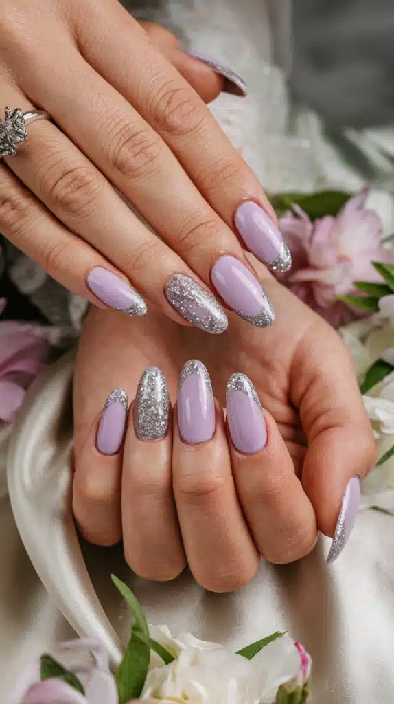 Soft lilac nails with silver glitter – a perfect touch of sparkle for spring! Elegant pastel lilac nails with a subtle silver glitter accent, creating a magical, soft springtime manicure.