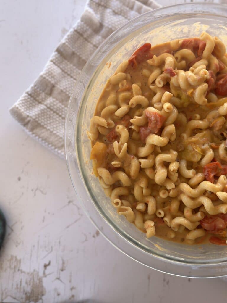 Creamy, protein-packed hummus pasta with roasted tomatoes Close-up of chickpea pasta coated in a flavorful hummus and tomato sauce.
